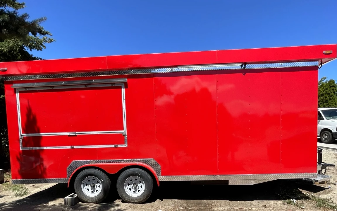 The bright red Tacos La Oaxaqueña food trailer